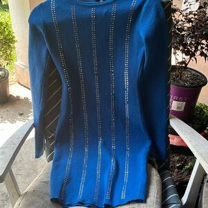 A high quality blue long sleeve dress with rhinestones on it